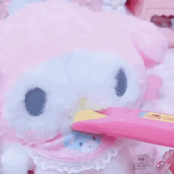A bunny plushie eating pudding.