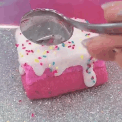 A person digging in a fuschia-colored dessert with a spoon.