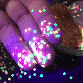 A person holding lumiscent stars.